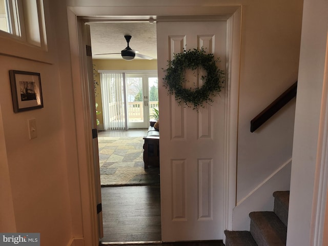 entryway with wood-type flooring and ceiling fan