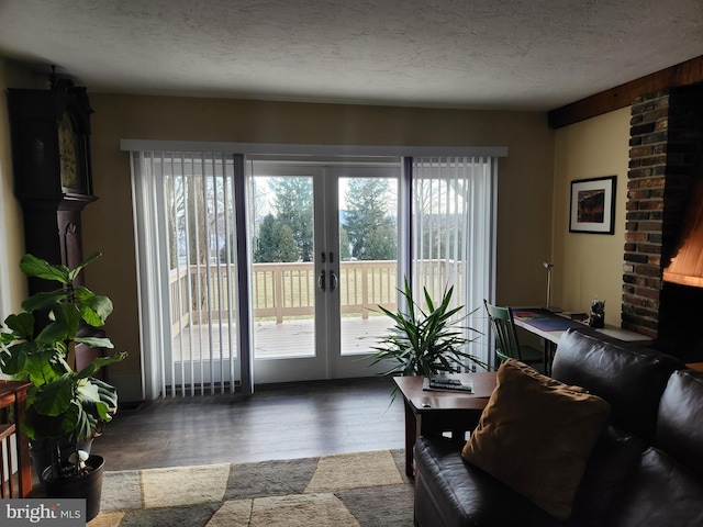 interior space featuring hardwood / wood-style floors, a textured ceiling, and french doors