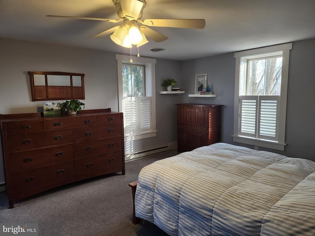 carpeted bedroom with ceiling fan and baseboard heating