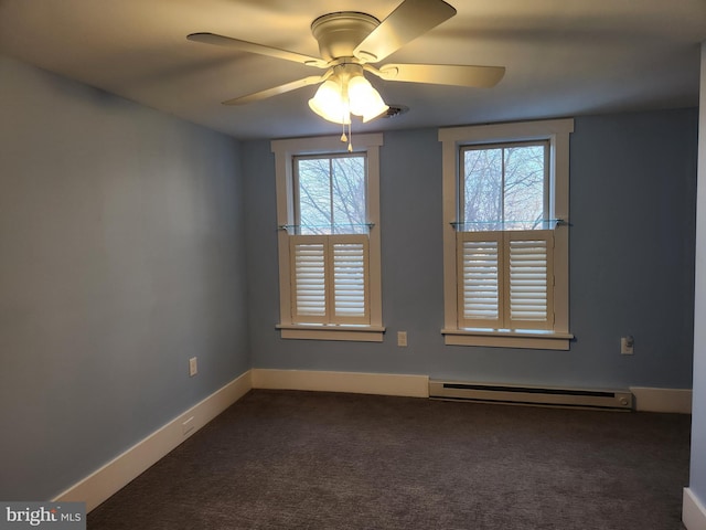 carpeted spare room featuring a baseboard radiator, a wealth of natural light, and ceiling fan