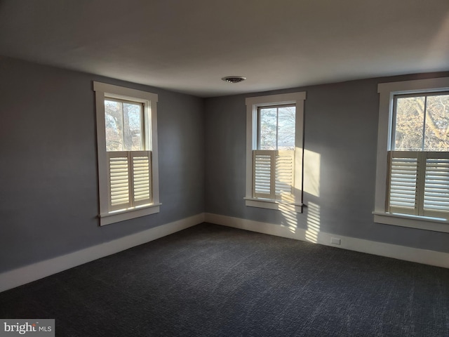 spare room with carpet floors and a healthy amount of sunlight