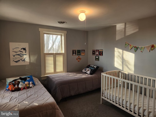 bedroom featuring dark carpet