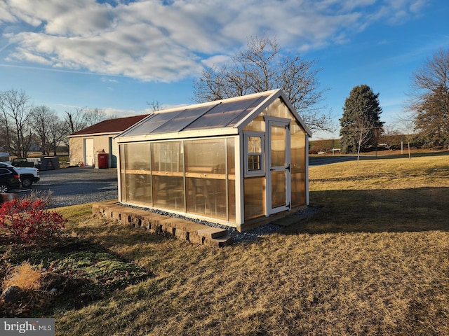 view of outdoor structure featuring a lawn