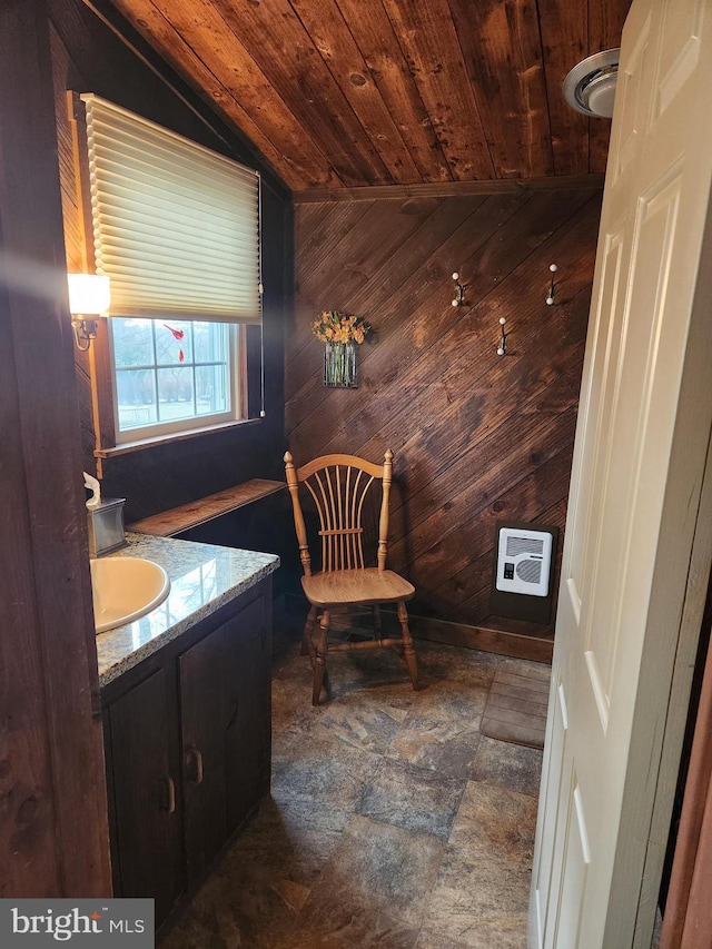 bathroom featuring vanity, wood ceiling, and wood walls