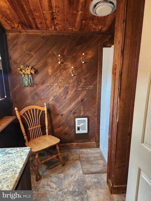 sitting room with wood ceiling and wood walls