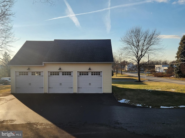 view of garage at dusk