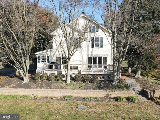 back of property featuring a wooden deck