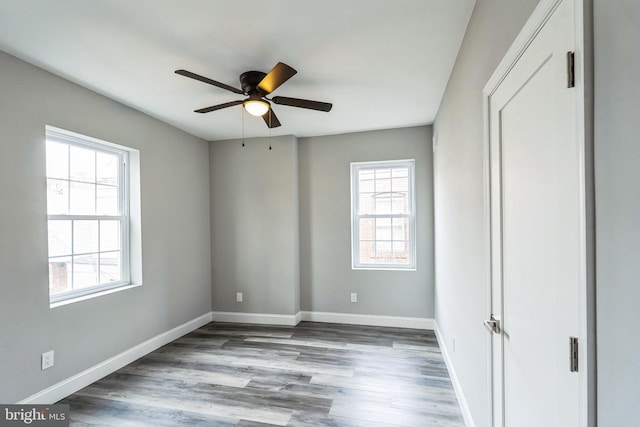 unfurnished bedroom with ceiling fan and hardwood / wood-style floors