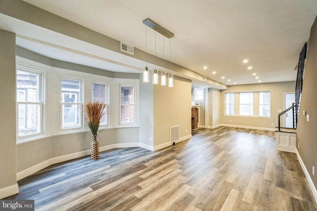 unfurnished living room featuring wood-type flooring