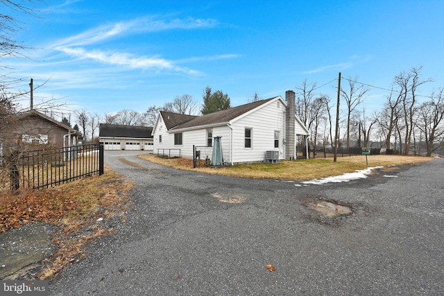 view of home's exterior featuring a garage and central AC