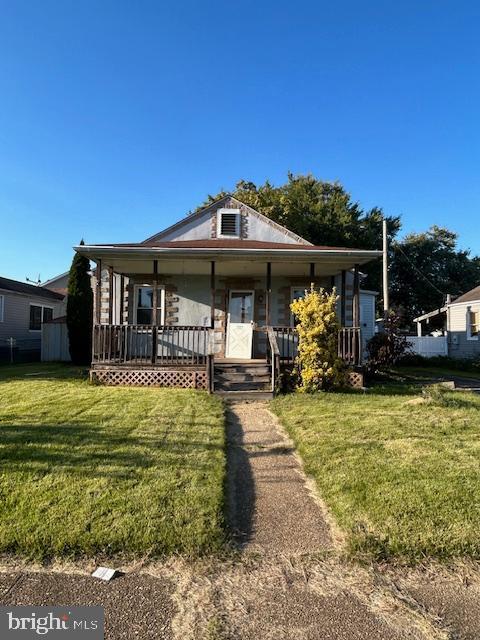 bungalow-style house with a front yard and a porch