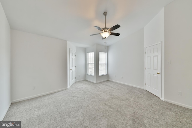 spare room featuring light colored carpet and ceiling fan