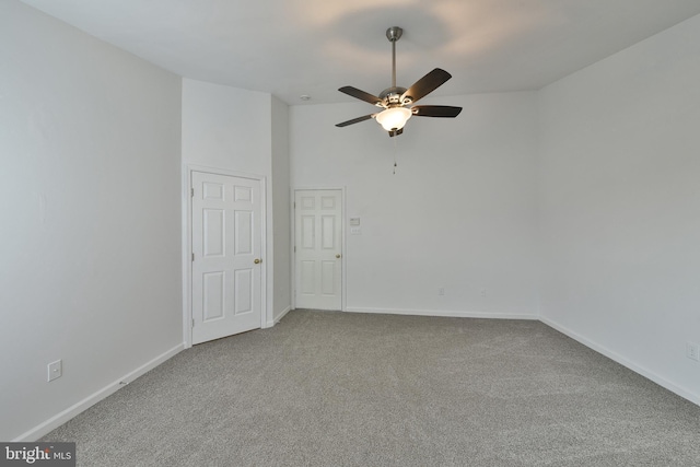 spare room with ceiling fan, carpet flooring, and high vaulted ceiling