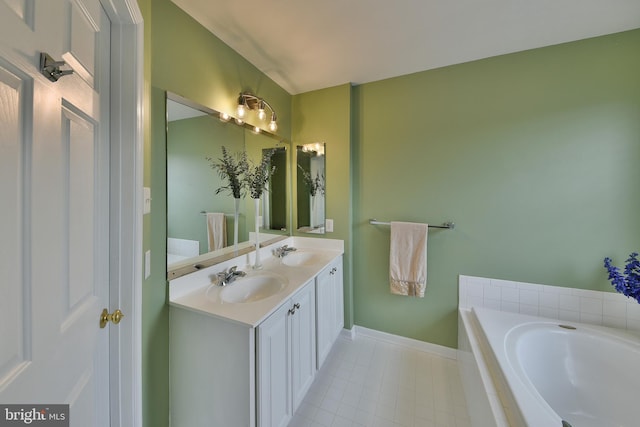 bathroom with vanity, tiled bath, and tile patterned floors