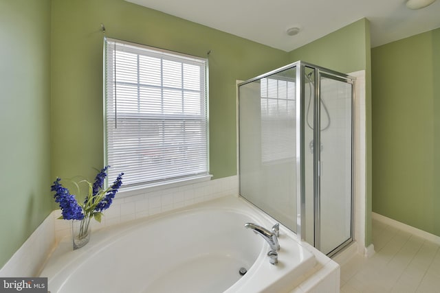 bathroom featuring independent shower and bath