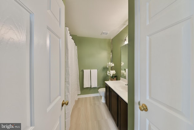 bathroom with vanity, radiator heating unit, and toilet