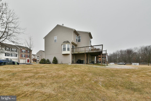 back of property featuring a lawn and a deck