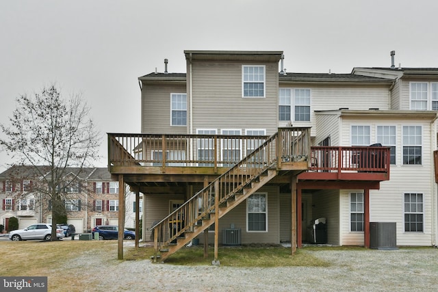 back of house featuring central AC and a deck