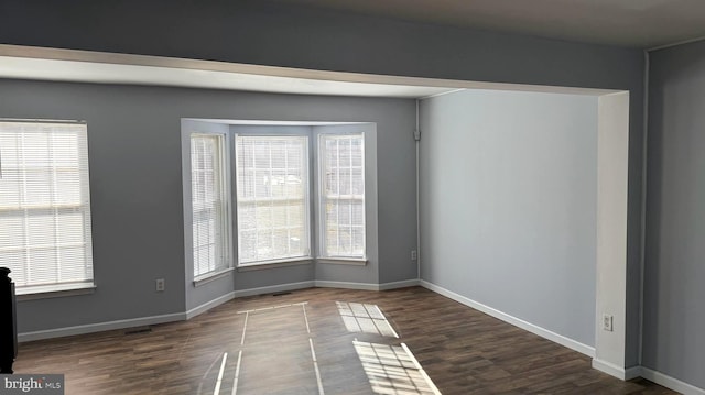 spare room with dark hardwood / wood-style floors