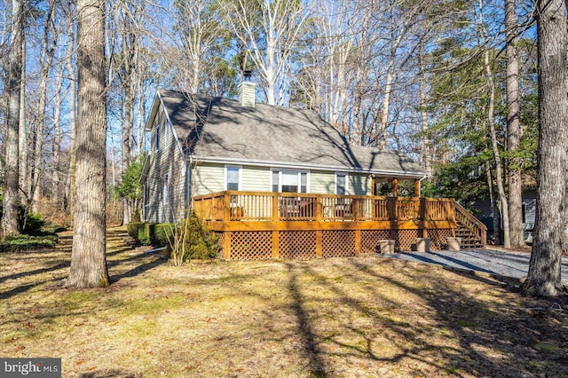 back of property featuring a yard and a deck