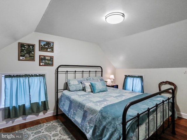 bedroom featuring lofted ceiling and dark wood-type flooring