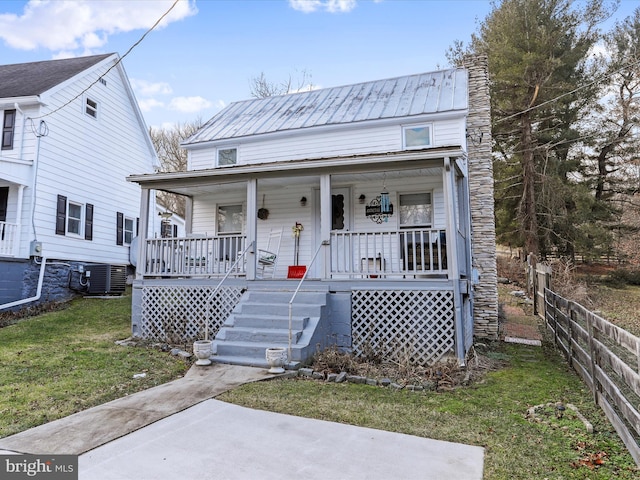 bungalow-style home with a front yard and covered porch