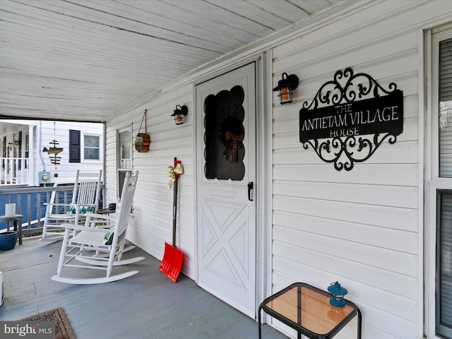 view of exterior entry with covered porch