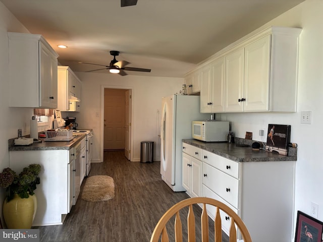 kitchen with ceiling fan, dark wood-type flooring, white cabinets, and white appliances