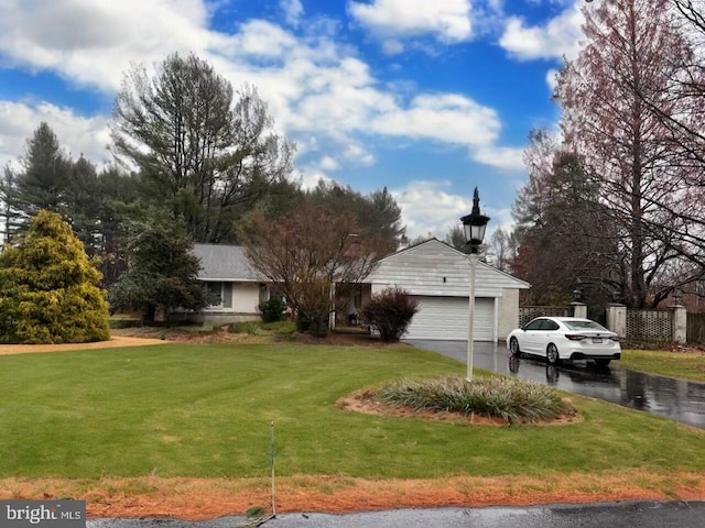 exterior space featuring a garage and a front yard