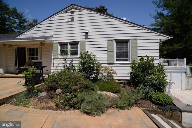 view of property exterior with a patio area