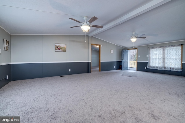 unfurnished living room featuring carpet, vaulted ceiling with beams, and ceiling fan