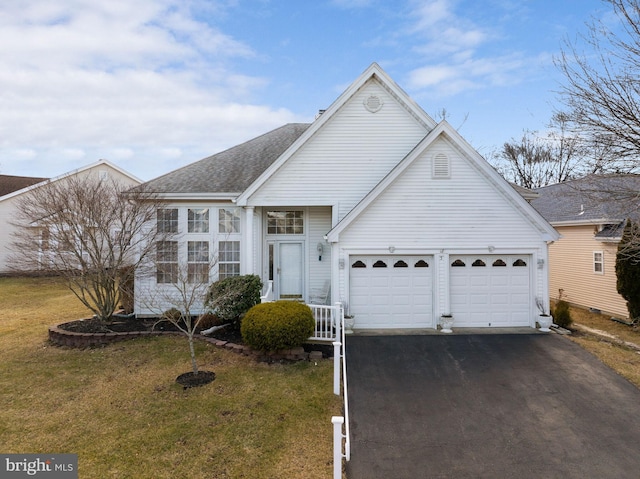 view of front of house featuring a garage and a front yard