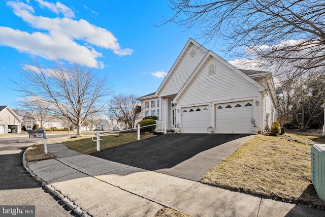 view of home's exterior with a garage and a yard