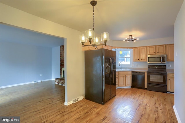 kitchen with light hardwood / wood-style flooring, sink, pendant lighting, and black appliances