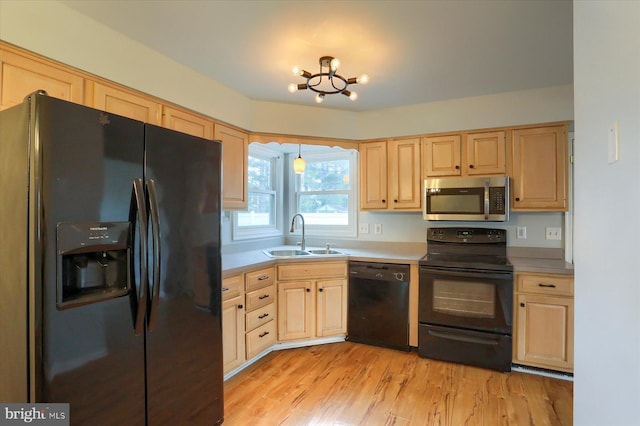 kitchen featuring light hardwood / wood-style floors, sink, light brown cabinets, and black appliances