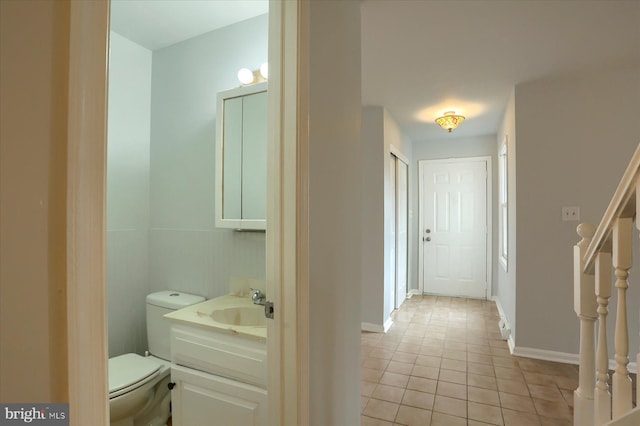 bathroom featuring tile patterned floors, toilet, and vanity