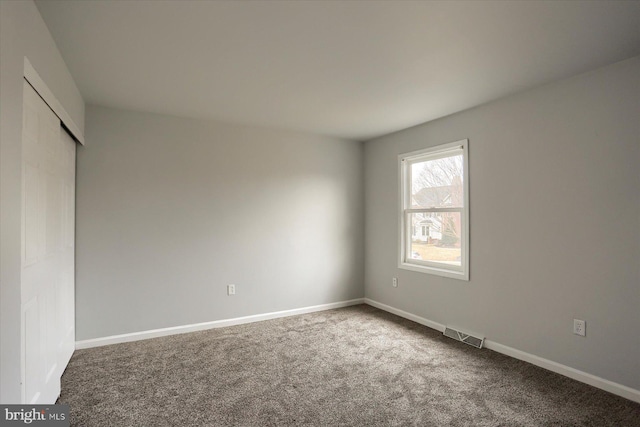 unfurnished bedroom featuring a closet and carpet