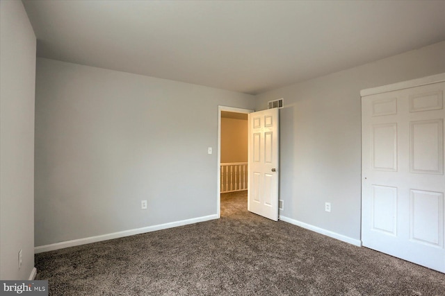 unfurnished bedroom featuring dark carpet