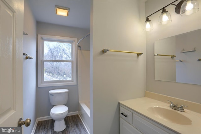 full bathroom with vanity, toilet,  shower combination, and wood-type flooring