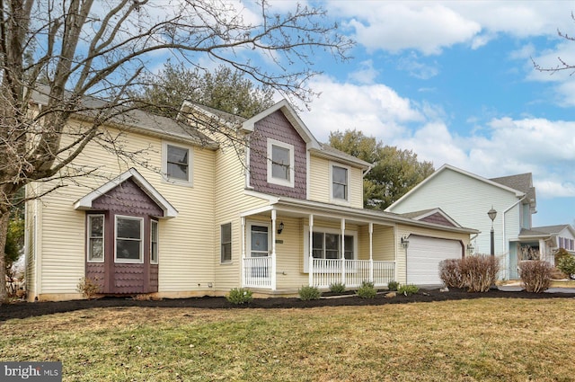 front facade with a garage, a front lawn, and a porch