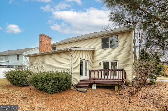 rear view of house featuring a wooden deck