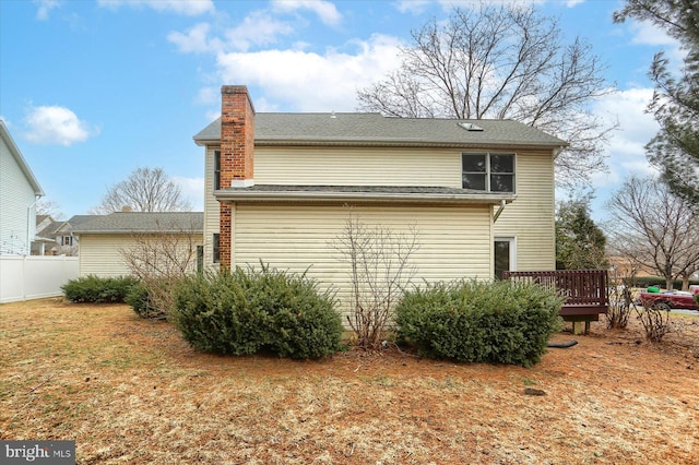 view of side of property featuring a yard and a deck