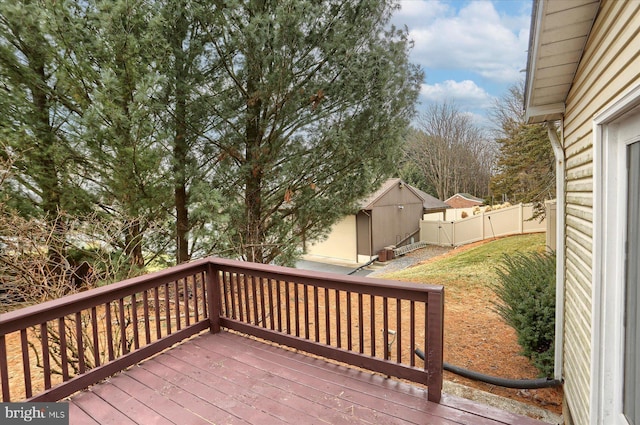 deck with a lawn and a shed