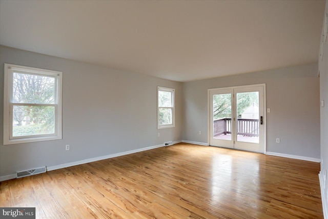 spare room with light hardwood / wood-style flooring