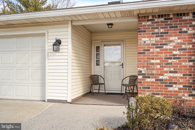 doorway to property with a garage