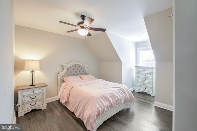 bedroom with vaulted ceiling, dark wood-type flooring, and ceiling fan