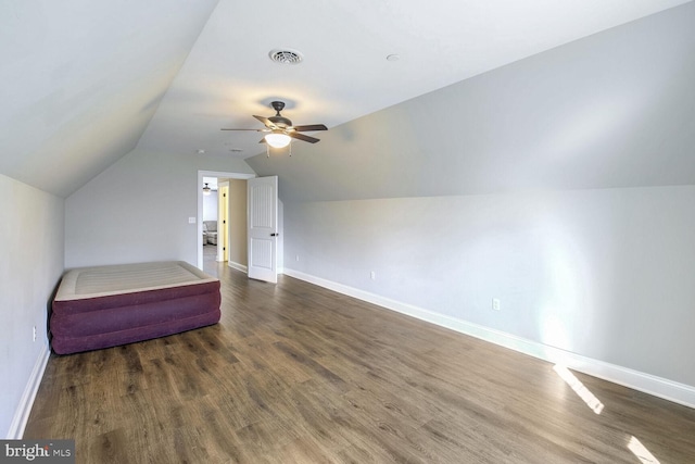 interior space with dark wood-type flooring, ceiling fan, and lofted ceiling