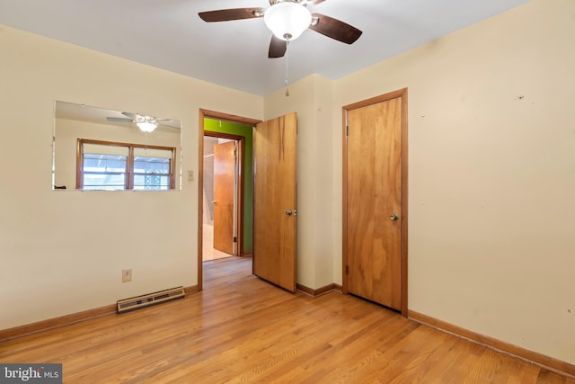 empty room with ceiling fan and light hardwood / wood-style floors