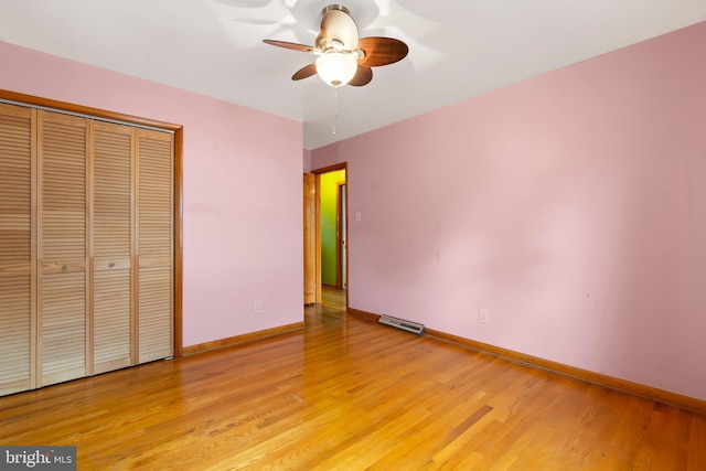 unfurnished bedroom featuring ceiling fan, light wood-type flooring, and a closet