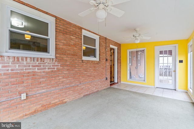 interior space with ceiling fan